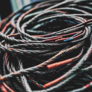 Close-up of braided wire harness with red identification bands, used for signal and control cable assemblies