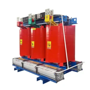 A front-three-quarter view of a dry-type cast resin power transformer with three large red-coated coils and yellow warning labels, mounted on a blue metal base frame, isolated on a white background.