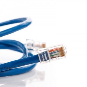 A circular arrangement of brightly colored Ethernet cables, including orange, blue, green, red, and yellow, tied together with their clear RJ45 connectors overlapping in the center on a white background.
