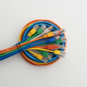 An abstract, digital illustration of fiber optic cables with brightly glowing blue and orange tips, conveying high-speed data transmission against a dark, dynamic background with light streaks.
