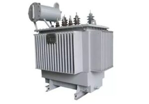 A side profile product photo of a grey oil-immersed distribution transformer with distinct corrugated cooling fins and high-voltage bushings, isolated on a white background.